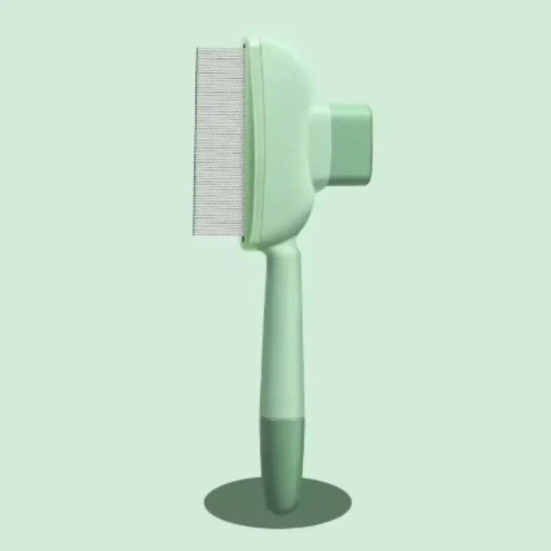 Sage green pet grooming brush with fine metal teeth and an ergonomic handle standing on a circular base.