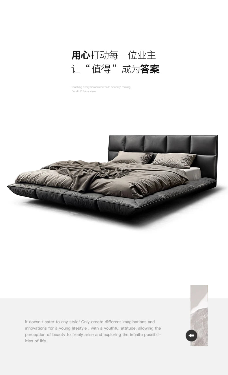 Modern, low-profile king-size bed in dark grey leather with a cushioned headboard and a sleek, floating design.