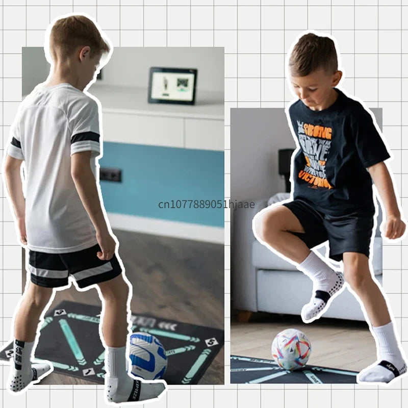 Boy practicing football skills on a black rectangular training mat with directional patterns, using a white soccer ball.