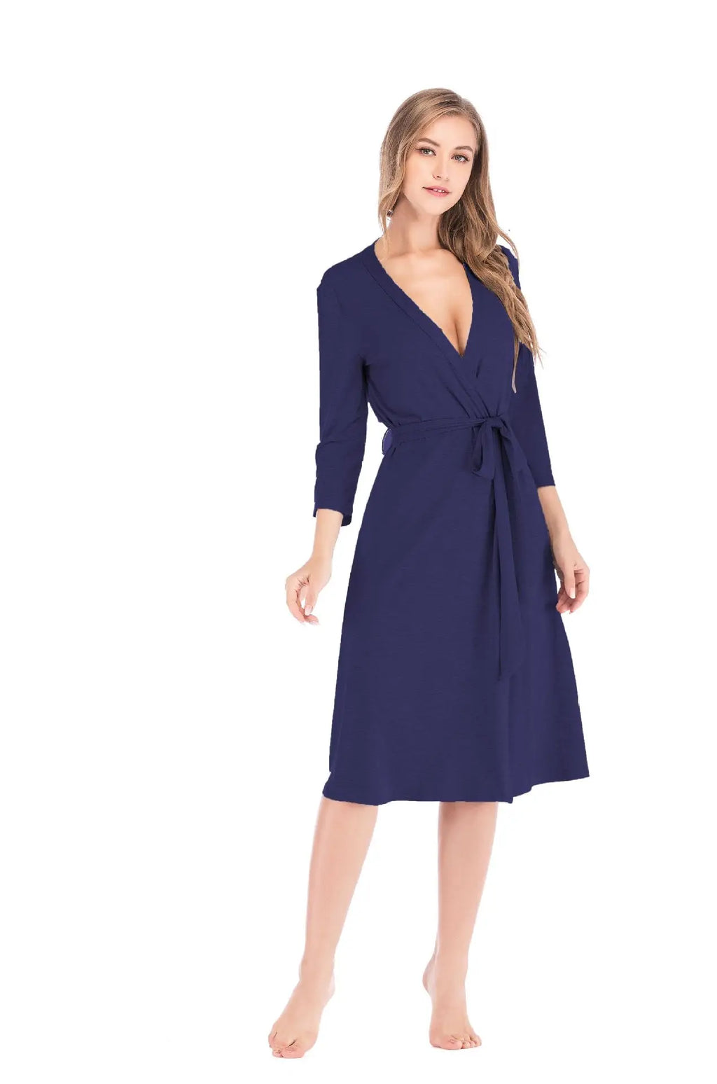 A woman wearing a navy blue knee-length wrap robe with three-quarter sleeves and a matching tie-waist belt.