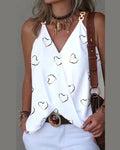 White sleeveless wrap-style camisole with gold heart print and metallic shoulder strap detail.