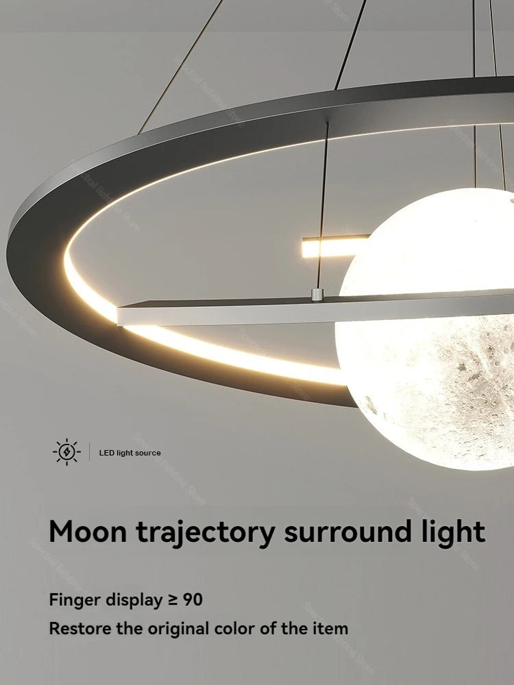 Modern black circular pendant light featuring a textured, glowing moon-like sphere and integrated LED rim lighting.
