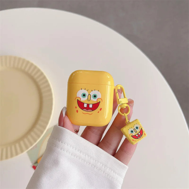 Yellow glossy SpongeBob SquarePants silicone case for AirPods 1/2 with matching character charm keyring.