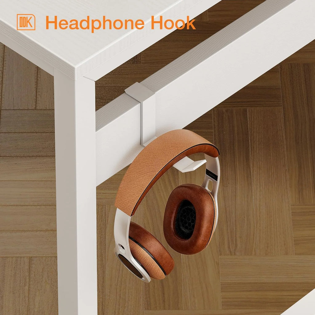 A white headphone hook clamps to the side of a white desk, holding brown and silver headphones.