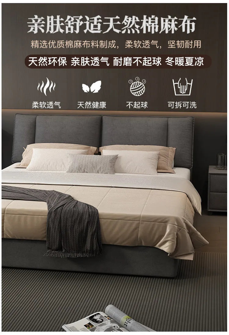Modern grey upholstered double bed with a tall headboard, smooth fabric finish, and integrated storage base.