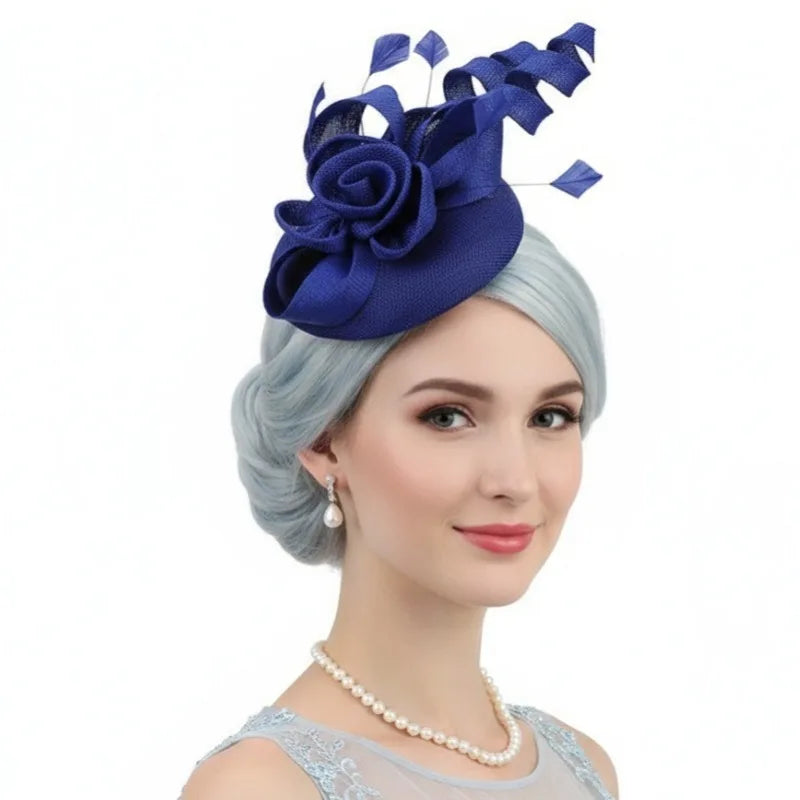 Royal blue occasion fascinator hat with a structured floral rose, feathers, and decorative ribbon loops.