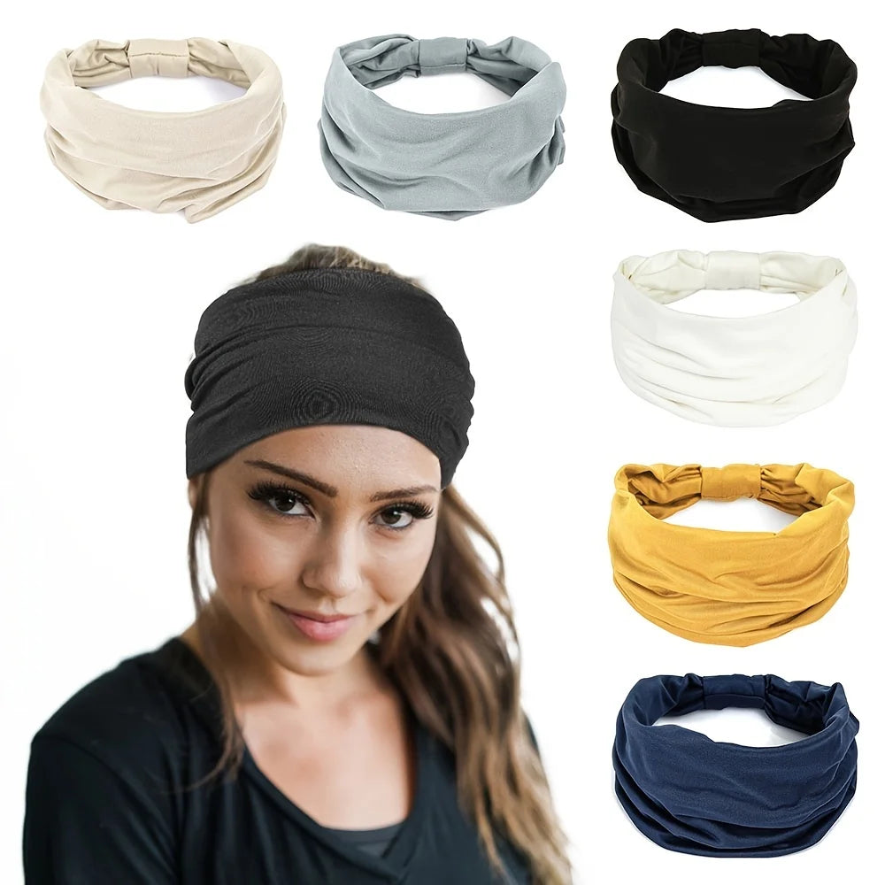 A woman wearing a wide black fabric headband, surrounded by similar headbands in beige, grey, black, white, gold, navy.