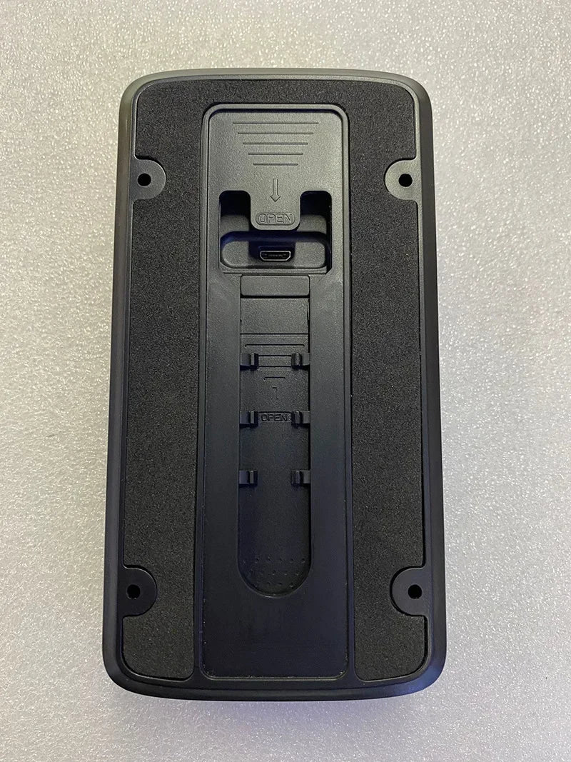 Back view of a black smart video doorbell showing mounting holes and a central USB charging port.