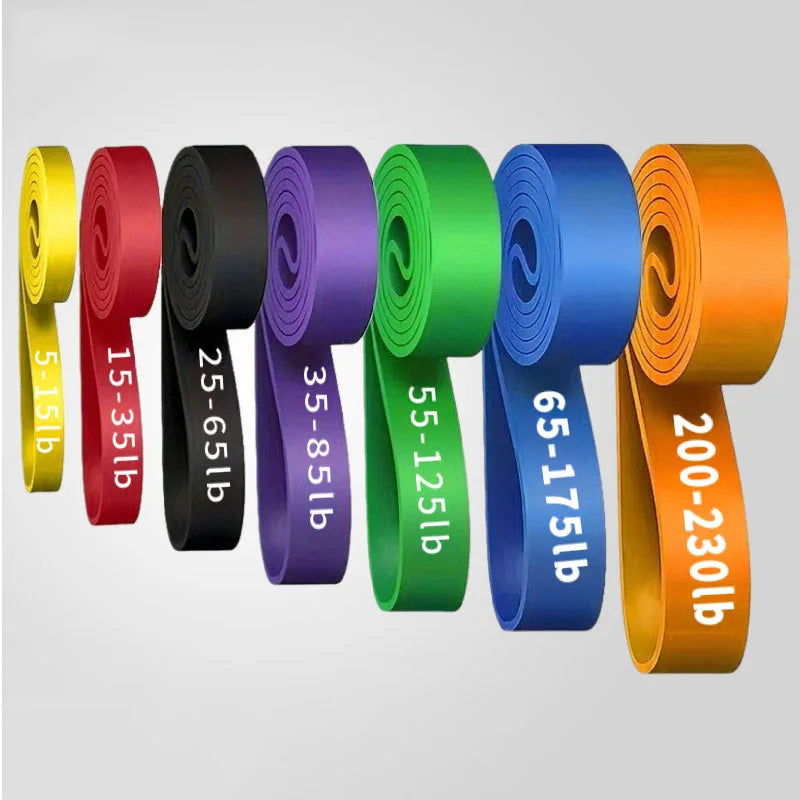 Seven rolled resistance bands in rainbow colours, each labelled with its specific weight resistance in pounds.