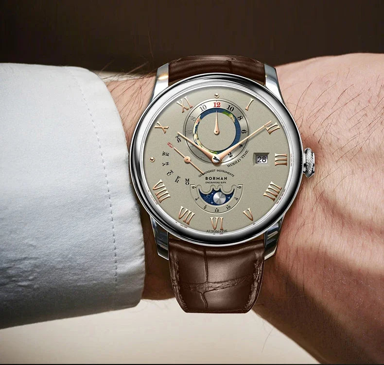 Men's automatic watch with a beige dial, rose gold Roman numerals, moon phase, and a brown leather strap on a wrist.