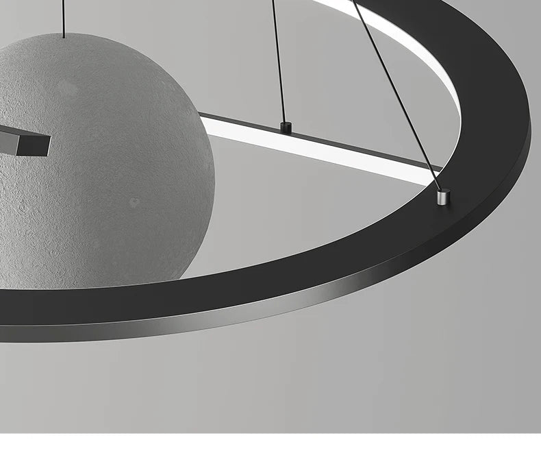 Modern black circular pendant lamp featuring a textured grey spherical centrepiece and integrated LED lighting.