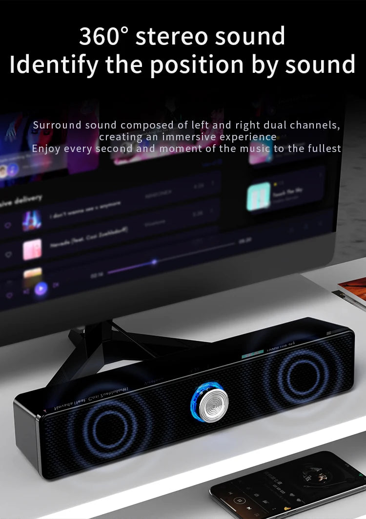 A sleek black USB wired computer soundbar with dual speakers and a central blue-lit volume dial.