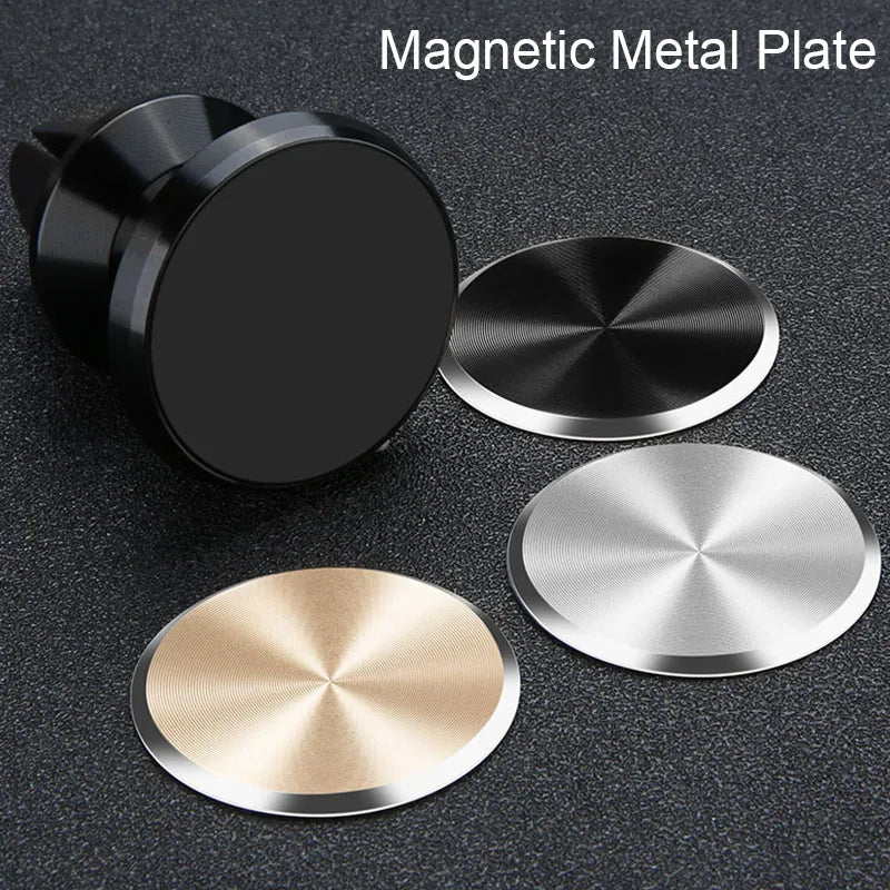 Black magnetic car mount with three round, metallic adhesive plates in black, silver, and gold finish.