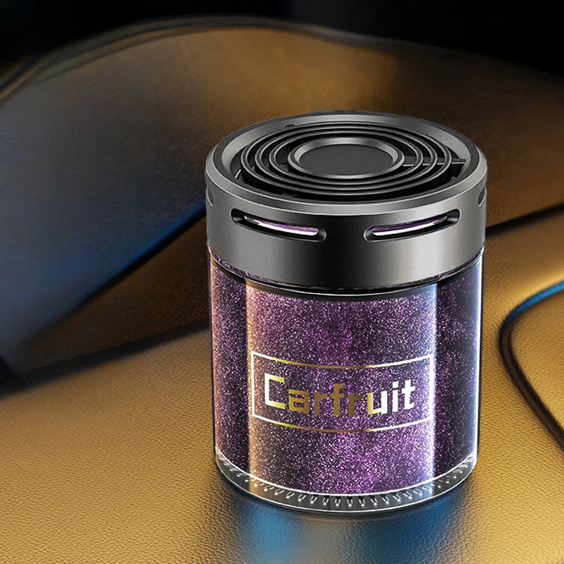Cylindrical car air freshener with a sparkling purple body and a sleek black vented lid.