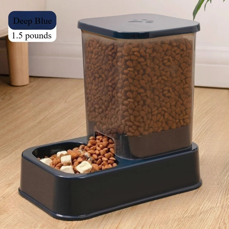 Deep blue automatic pet feeder with a translucent 1.5 lb food hopper and a wide, rectangular feeding bowl.