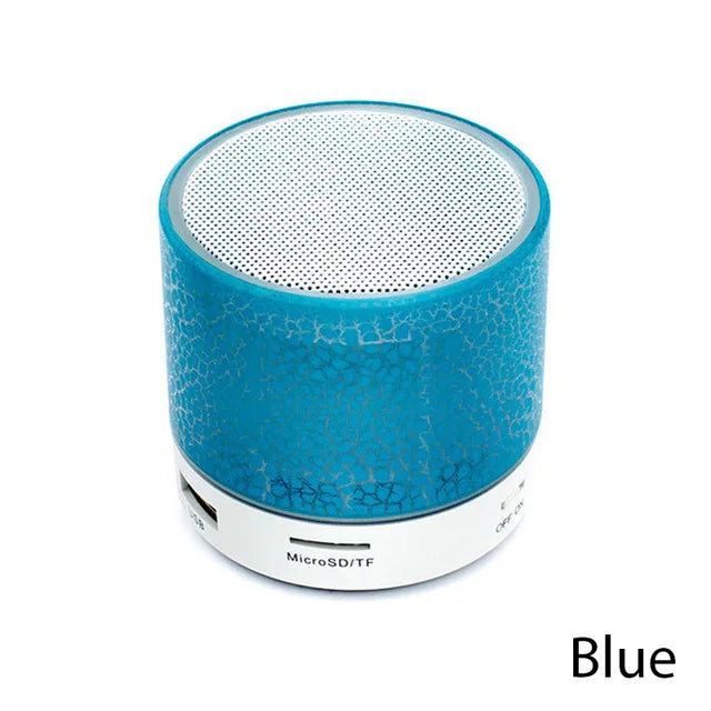 Portable blue mini Bluetooth speaker with a cracked-effect LED design and a white speaker grille.