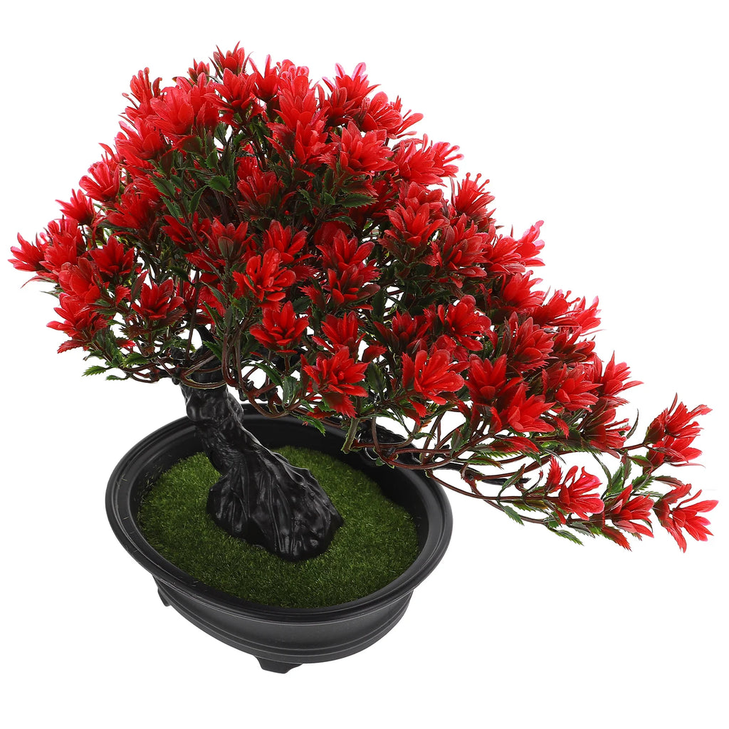 Artificial bonsai tree with vibrant red leaves, a textured black trunk, and faux grass in a black oval planter.