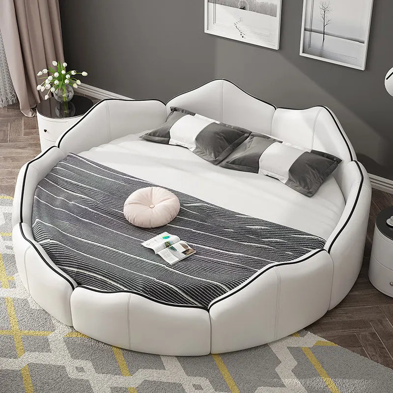 Luxury white faux leather round bed frame with a modern petal-shaped headboard and contrasting black piping detail.
