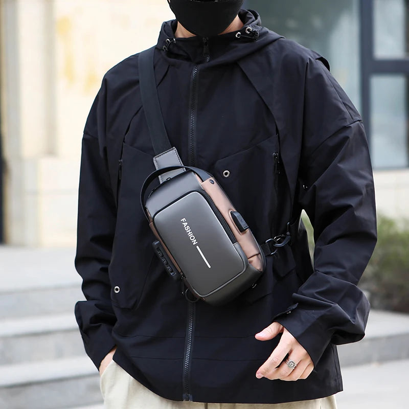 Sleek grey and bronze anti-theft chest bag with a built-in USB charging port, worn crossbody over a black jacket.