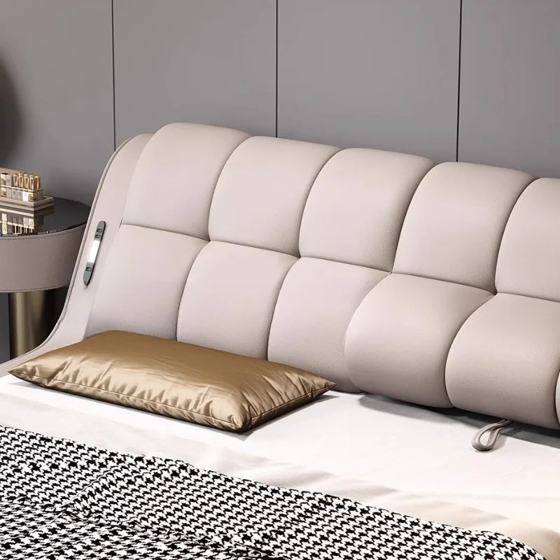 Modern, beige genuine leather bed frame with a plush, panelled headboard and integrated side control panel.