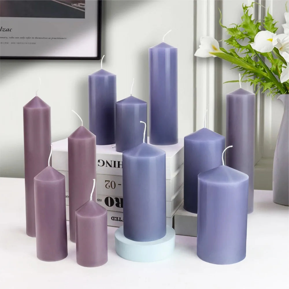Group of purple and blue pillar candles of various heights and thicknesses with wicks.