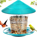 Turquoise bird feeder with a ridged conical roof, clear seed reservoir, and circular perch, surrounded by wild birds.