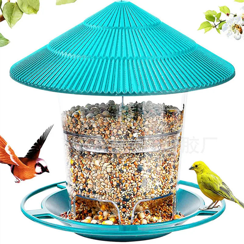 Turquoise bird feeder with a ridged conical roof, clear seed reservoir, and circular perch, surrounded by wild birds.