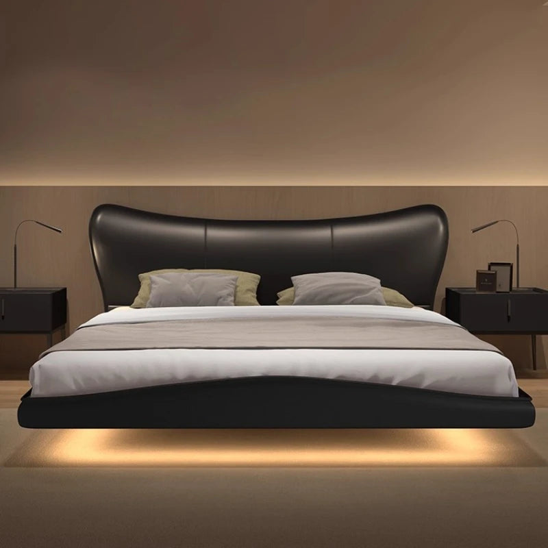 Modern black upholstered floating bed frame with a curved headboard and integrated under-bed lighting.