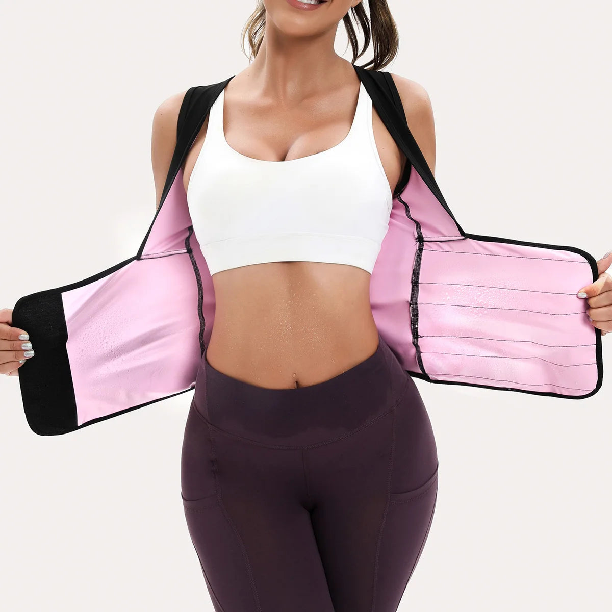 Black and pink women's waist trainer vest with a flexible, sweat-enhancing neoprene design for core support.
