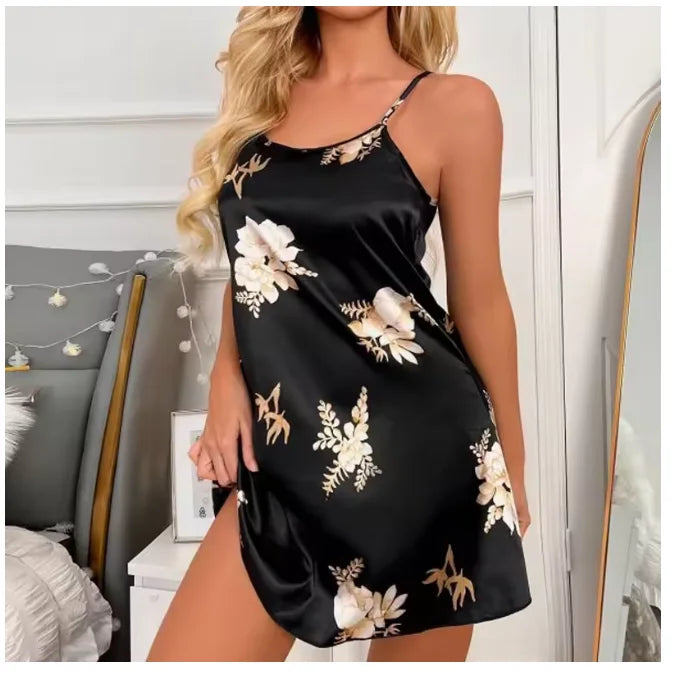 Black satin nightdress with spaghetti straps and a cream floral print, featuring a classic mini-length slip style.
