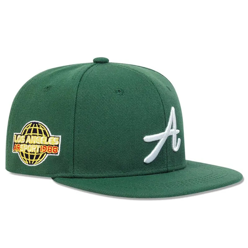 Green baseball cap featuring a white embroidered letter 'A' and a globe patch with 'Los Angeles' text on the side.