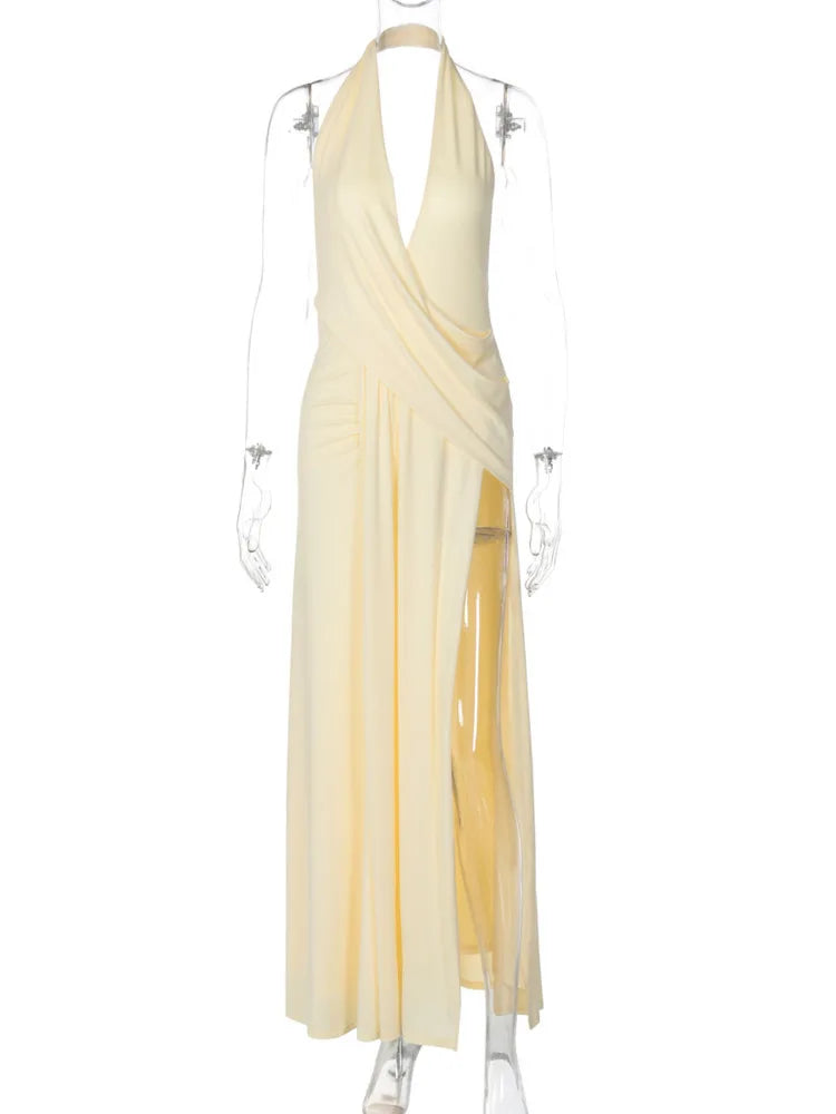 Pale yellow sleeveless maxi dress with a deep V-neck halter top, draped bodice, and high thigh slit.