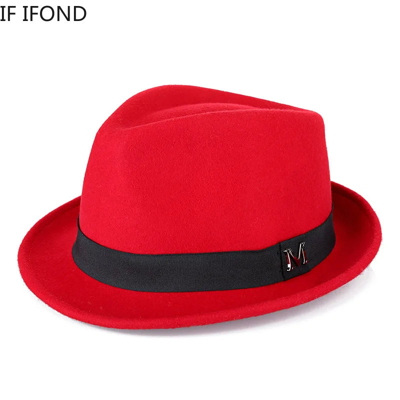 A bright red wool felt fedora hat featuring a black ribbon band and a metal "M" detail on the side.