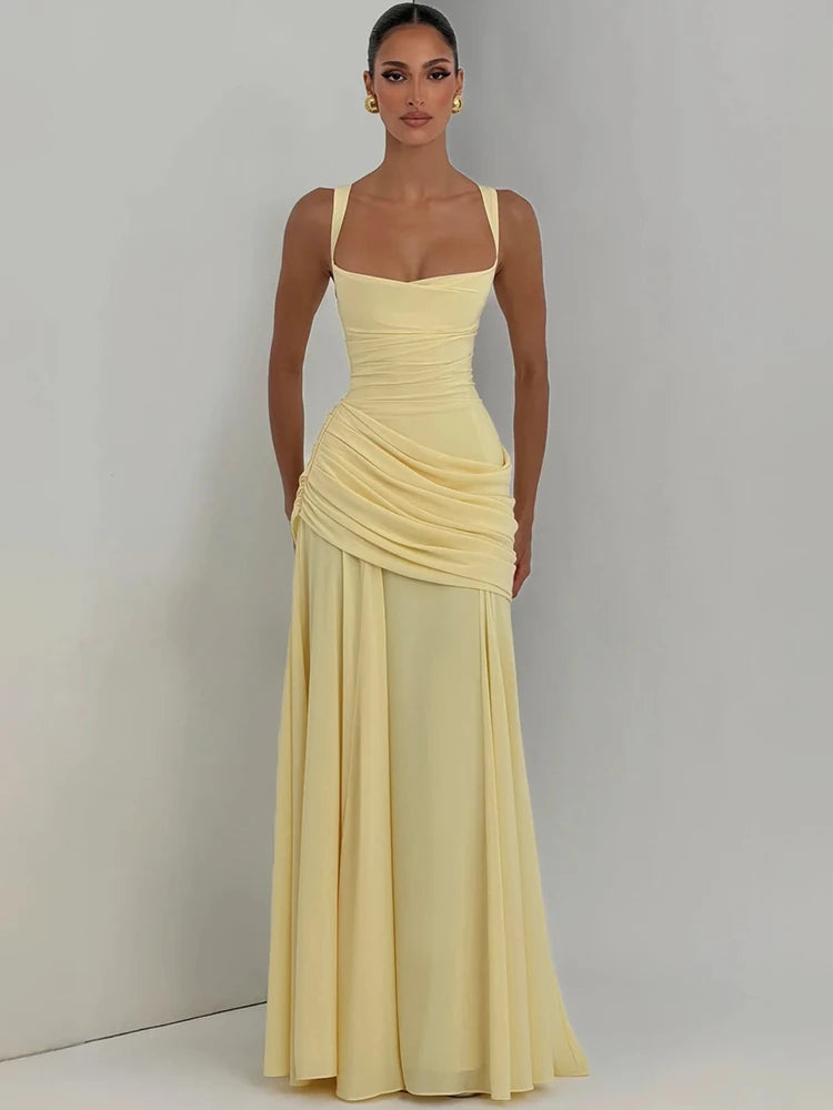 Pale yellow sleeveless maxi dress with a square collar, ruched bodice, and flowing pleated long skirt.