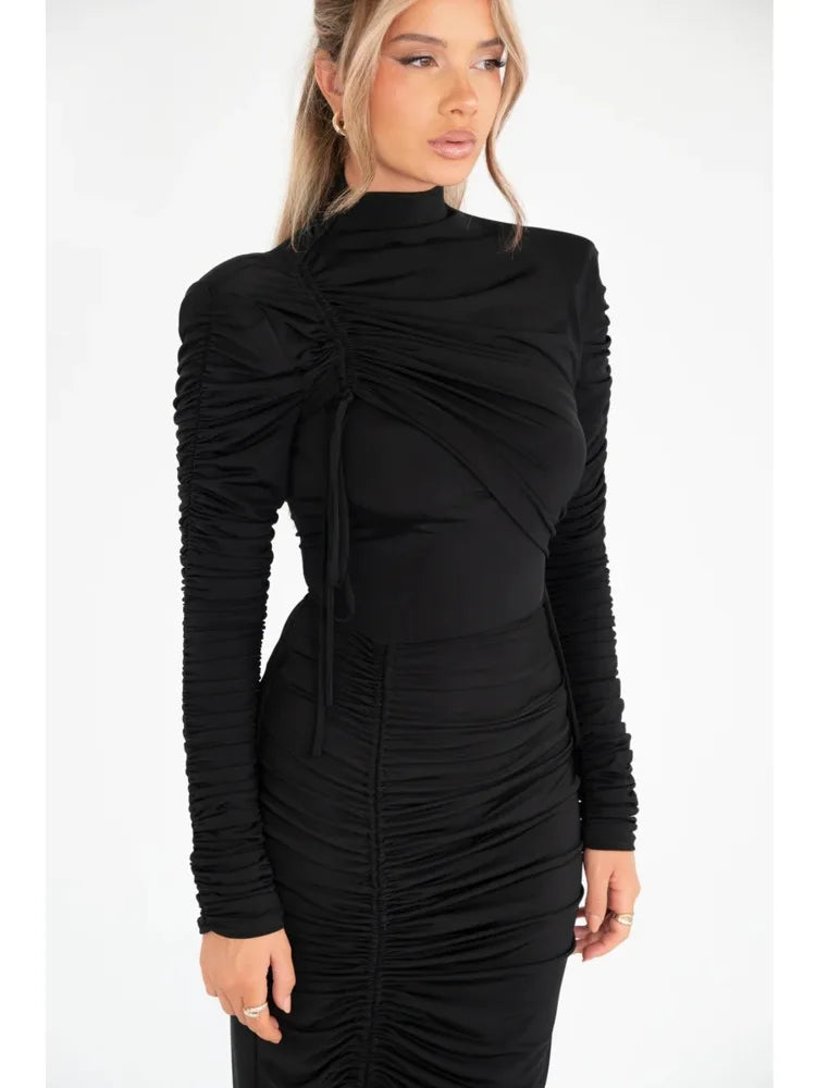 Black slim-fit long-sleeve maxi dress with mock neck, ruching details, and front drawstring tie.