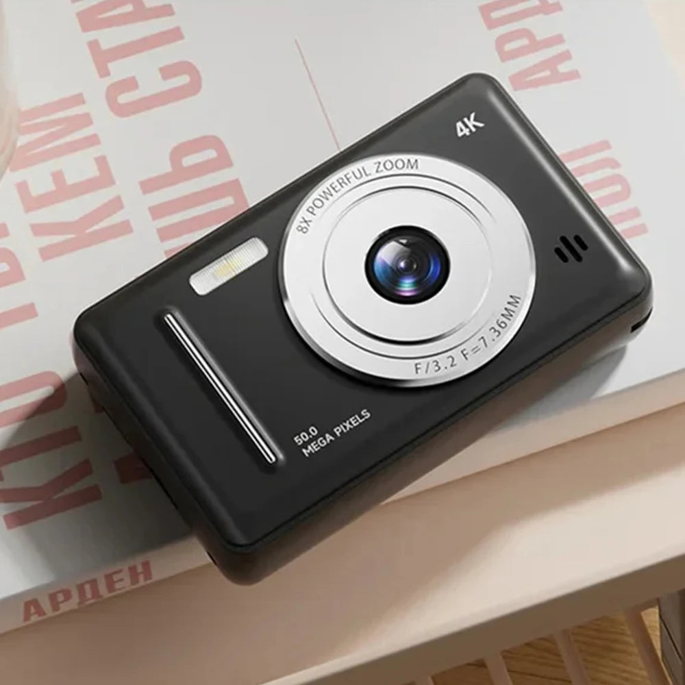 Compact black plastic 4K digital camera with a silver lens, 8x zoom, flash, and 50-megapixel resolution.