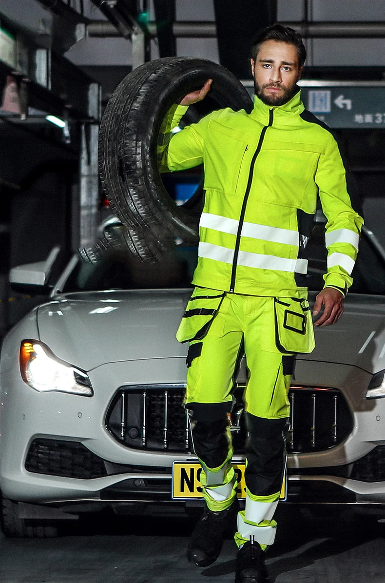 High-visibility yellow workwear jacket and trousers with reflective strips, black accents, and multiple utility pockets.