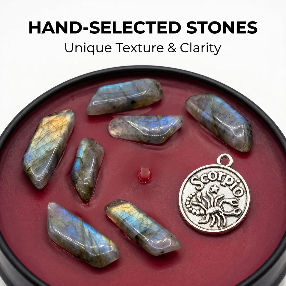 Red candle featuring polished, iridescent labradorite stones and a round silver Scorpio zodiac charm.