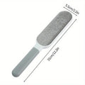 White and grey reusable lint brush with a textured fabric head and ergonomic handle, showing 31cm length.