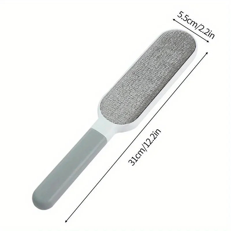 White and grey reusable lint brush with a textured fabric head and ergonomic handle, showing 31cm length.