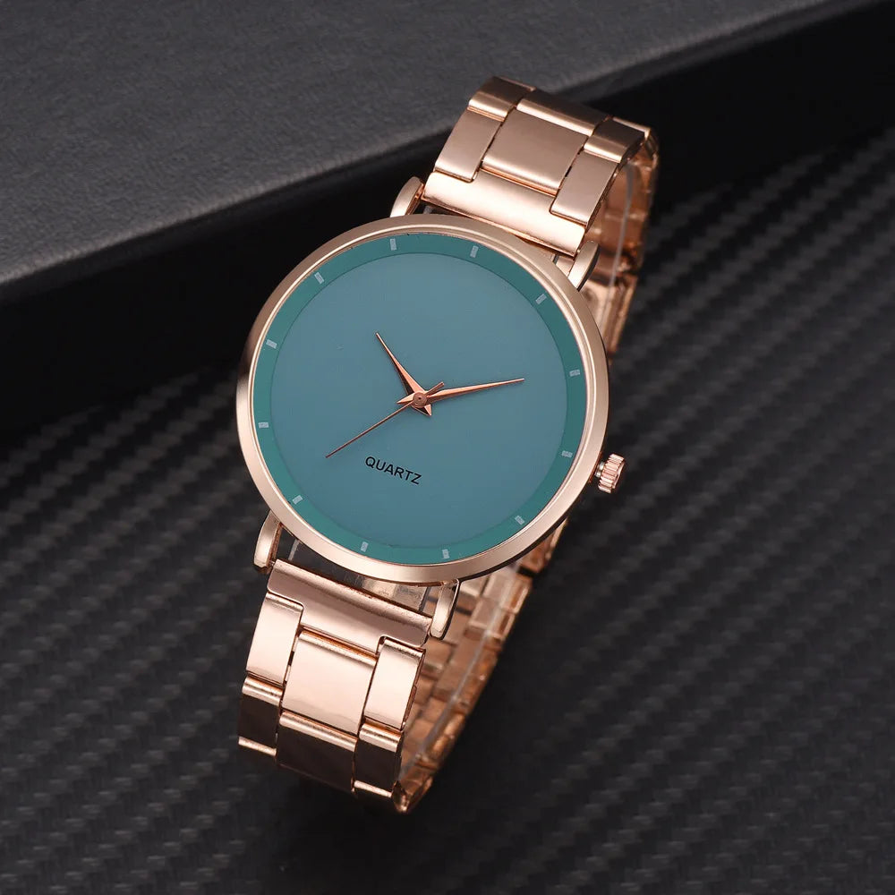 Elegant ladies' rose gold stainless steel watch with a minimalist teal face and matching slim hands.