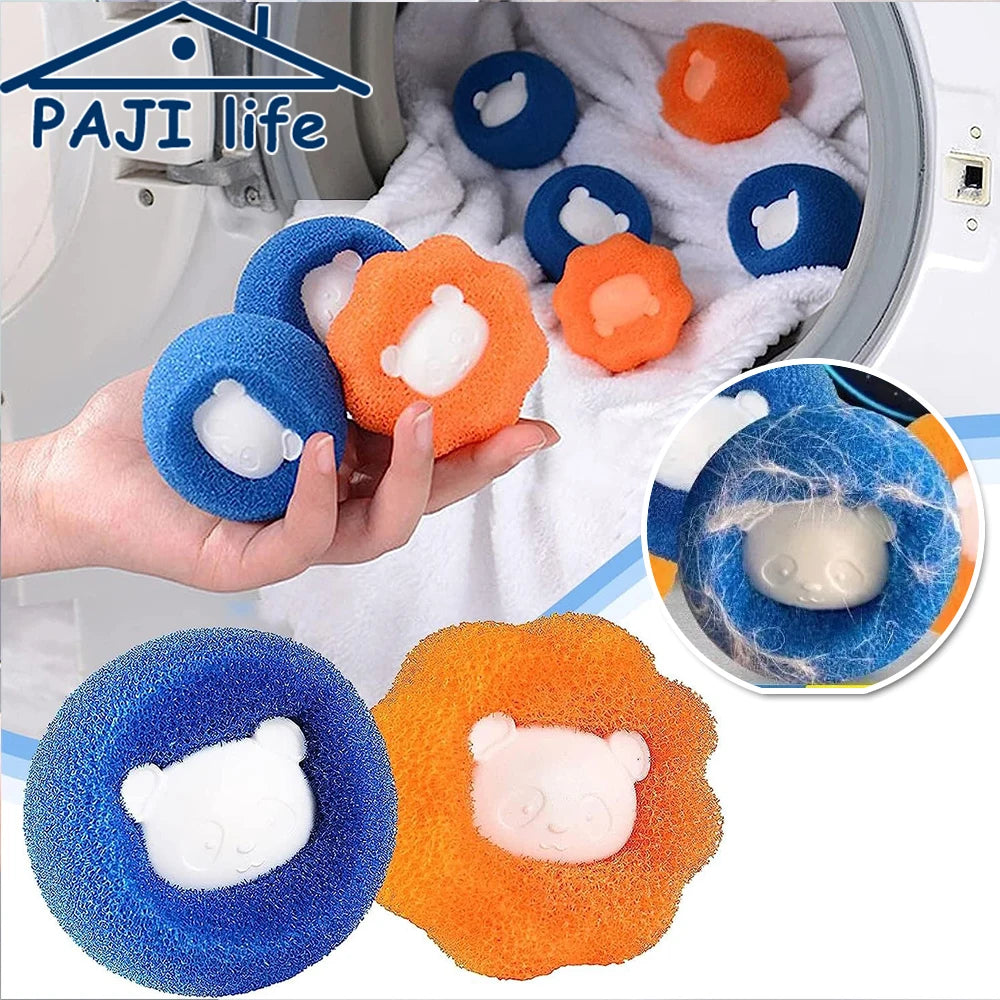 Blue and orange bear-shaped laundry hair catcher sponges in a washing machine with a white towel.