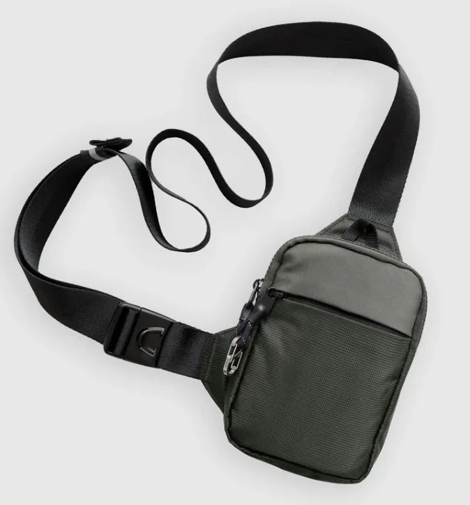 Dark grey nylon unisex crossbody sling bag with a secure zip, adjustable strap, and side-release buckle.