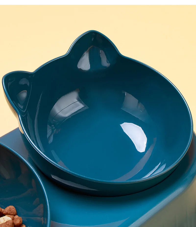 Dark teal, cat-shaped pet feeding bowl with a smooth, glossy finish on a matching raised stand.