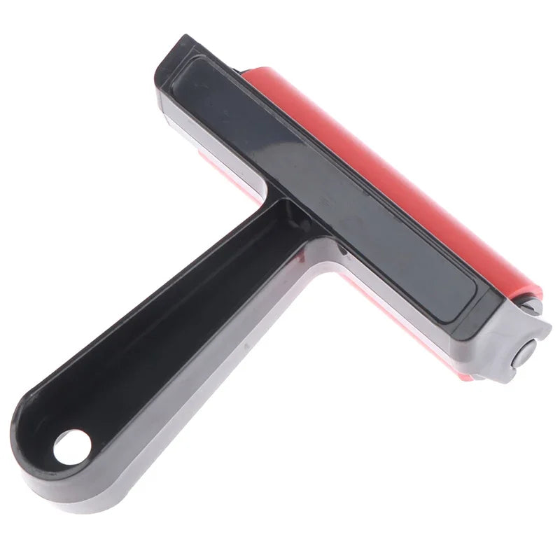 Rubber craft brayer with a red roller and black handle, featuring a hole in the handle for easy hanging storage.