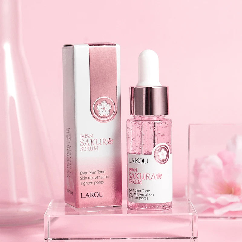 Pink sakura facial serum in a dropper bottle with matching box, designed for skin rejuvenation and pore tightening.