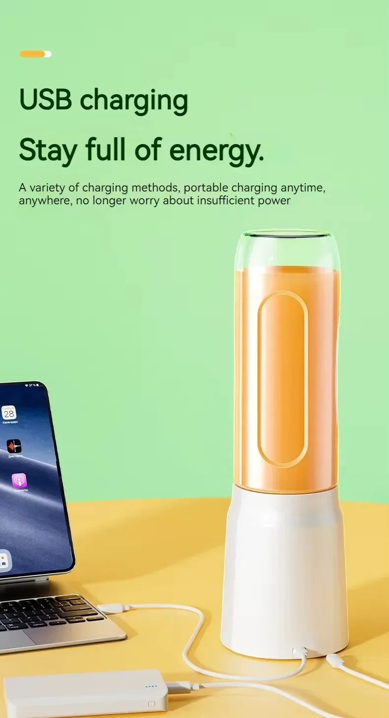 Portable USB-rechargeable personal blender with a white base and orange drink container, sitting on a yellow desk.