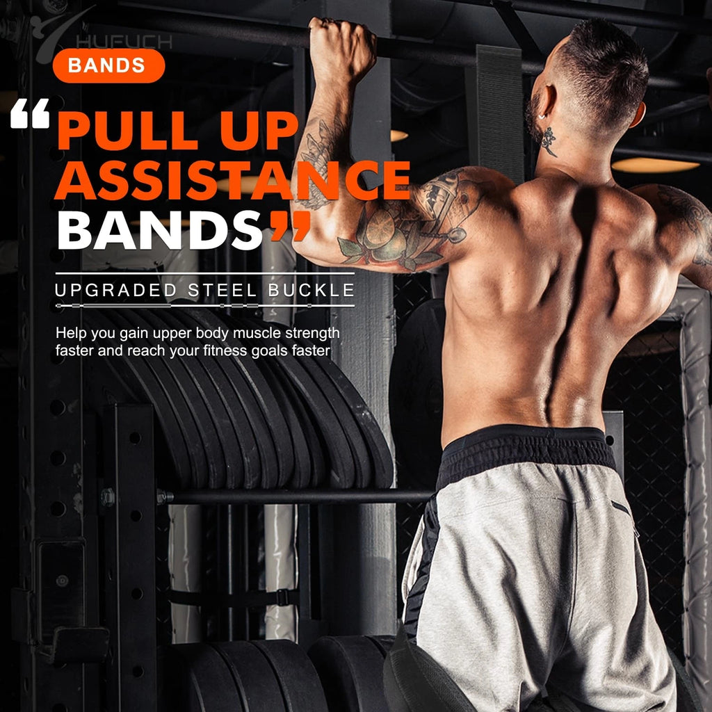 Man with tattoos using black pull up assistance bands and hanging rope on a bar in gym.