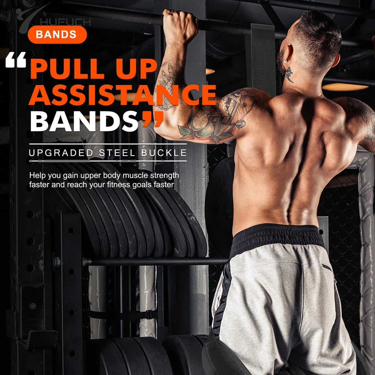 Man with tattoos using black pull up assistance bands and hanging rope on a bar in gym.