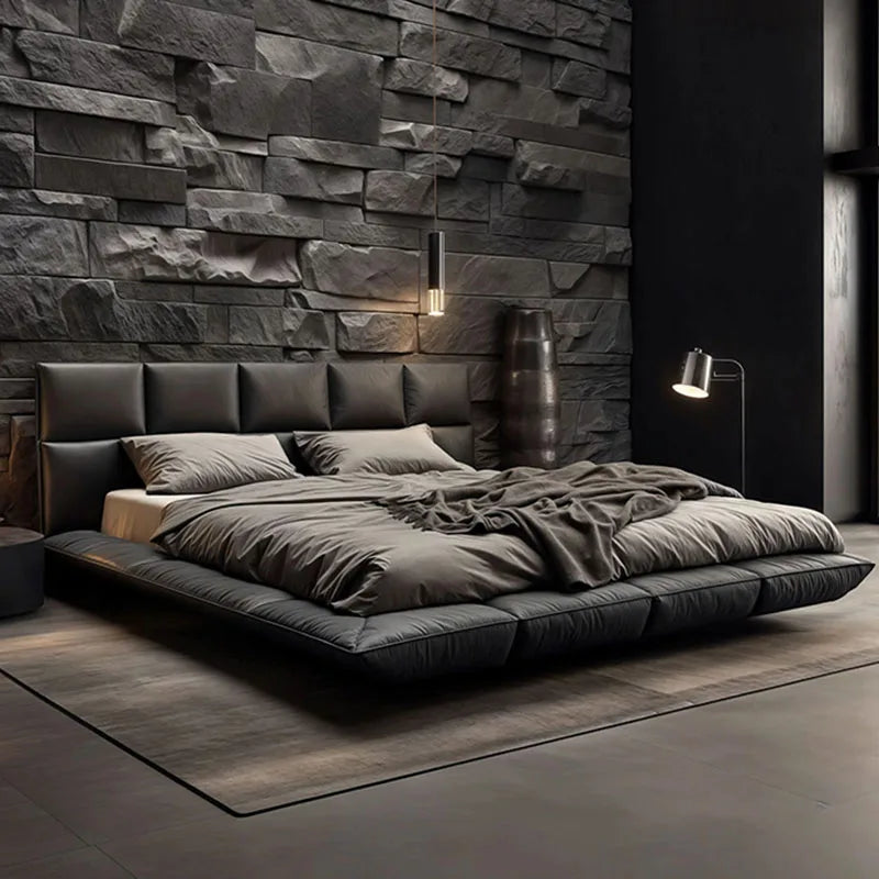 Modern charcoal grey leather king-size bed with a sleek floating base and a cushioned, segmented headboard.